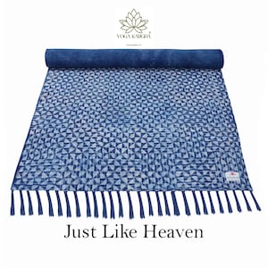 May include: A blue and white cotton yoga mat with a geometric pattern and fringe. The mat is rolled up and has a tag that says "Just Like Heaven".