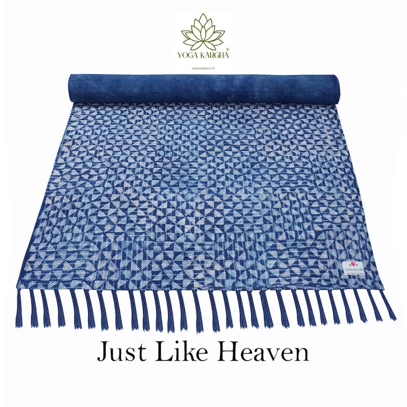 May include: A blue and white cotton yoga mat with a geometric pattern and fringe. The mat is rolled up and has a tag that says "Just Like Heaven".