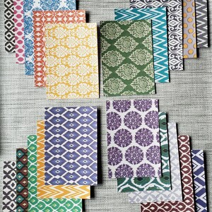 May include: Assortment of patterned paper sheets in various colors and designs, including geometric, floral, and abstract patterns.