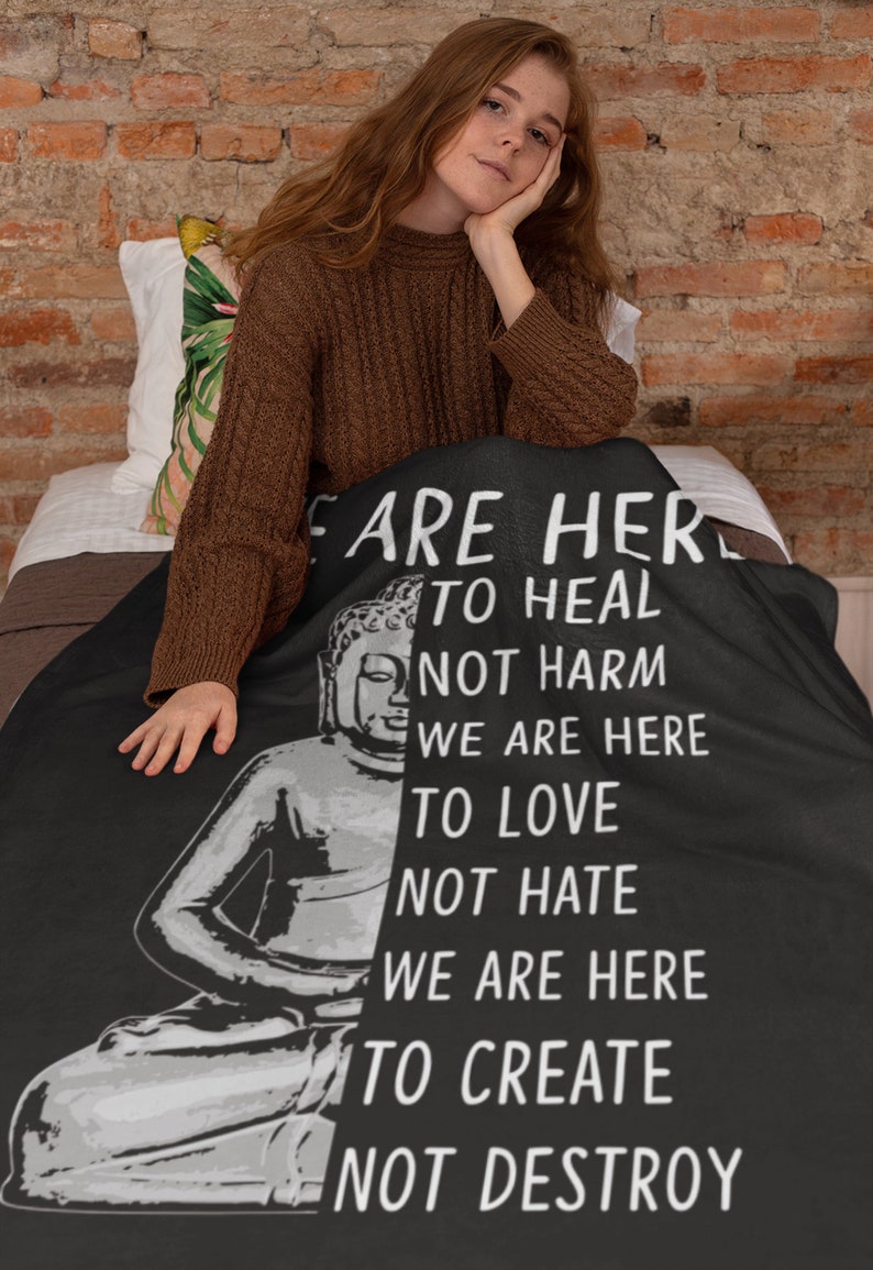 May include: Black throw blanket with a white image of a meditating Buddha and text that reads "We are here to heal not harm, we are here to love not hate, we are here to create not destroy."