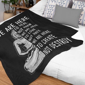 May include: Black throw blanket with a white Buddha image and the text "We are here to heal, not harm, to love, we are here, not hate, we are here to create, not destroy".
