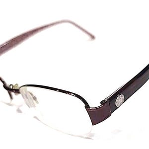 May include: Dark brown framed eyeglasses with clear lenses. The frame has a semi-rimless design, and the temples are also dark brown. A small silver emblem is on the temple. The glasses are set against a white background.