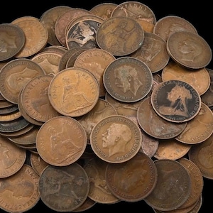 May include: A pile of old bronze pennies, displaying portraits and inscriptions. The coins, in various states of wear, are arranged against a black backdrop. The collection includes coins of different sizes and shapes, showcasing their historical value.