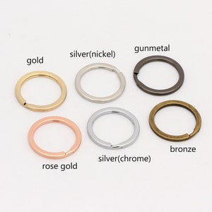 May include: Six key rings in different finishes: gold, silver (nickel), gunmetal, rose gold, silver (chrome), and bronze.