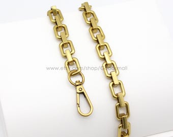 May include: A gold-toned chain with a square link design. The chain has a clasp on one end and is approximately 40 inches long.