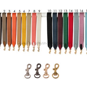May include: A collection of 17 colorful purse straps in various shades, including black, blue, red, and pink, with gold-colored clasps. The straps are displayed on a white bar, with four different clasp styles below.