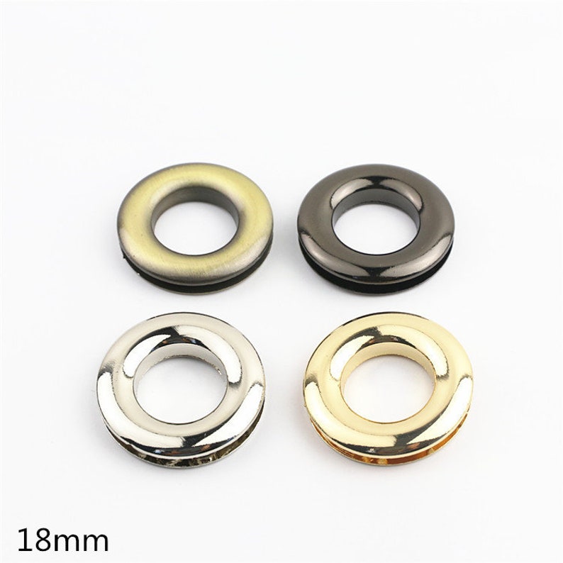 May include: Four metal grommets in different finishes: gold, silver, black, and antique gold. Each grommet is 18mm in diameter.