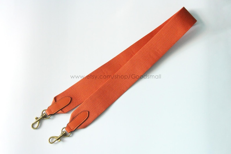 May include: Orange bag strap with gold-tone clasps and leather accents. The strap is made of a textured, woven material. The Etsy shop URL is visible in the image.