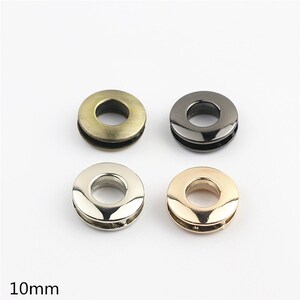 May include: Four metal grommets in different finishes: antique brass, black, silver, and rose gold. Each grommet has a 10mm inner diameter.