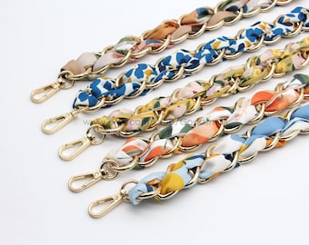 May include: Five gold chain straps with different floral patterned fabric woven into the chain. The straps have a gold hook clasp at the end.