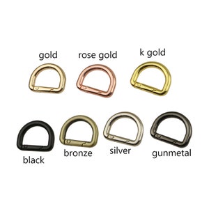 Puede incluir: Un conjunto de 10 anillas en D de metal en varios acabados, incluyendo oro, oro rosa, oro k, negro, bronce, plata y metal de pistola.