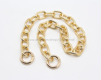May include: A gold chain with two oval-shaped clasps. The chain is made of thick, linked metal.