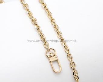 May include: A gold chain with a lobster clasp. The chain is made of metal and has a shiny finish.