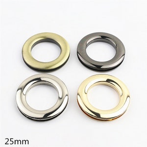 May include: Four metal rings in different finishes: antique brass, black nickel, silver, and gold. Each ring has a 25mm inner diameter.