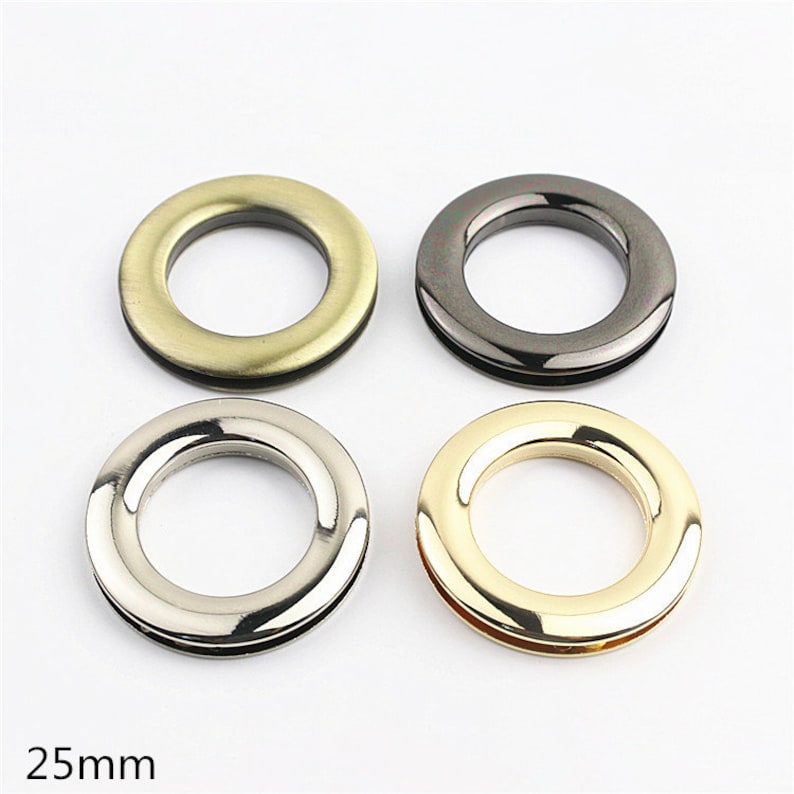 May include: Four metal rings in different finishes: antique brass, black nickel, silver, and gold. Each ring has a 25mm inner diameter.