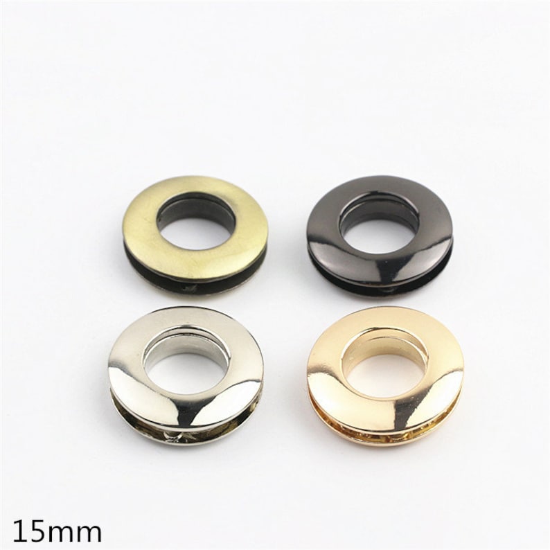 May include: Four metal eyelets in different finishes: gold, silver, brass, and black. Each eyelet is 15mm in diameter.