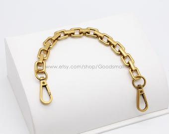 May include: Gold-toned chain with two swivel clasps. The chain is made of square links and is approximately 15 inches long.
