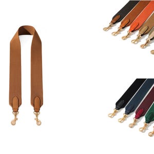 May include: A brown shoulder bag strap with gold-colored clasps. Additional straps in various colors, including black, orange, tan, yellow, pink, white, navy, burgundy, green, red, and light blue, are also displayed.