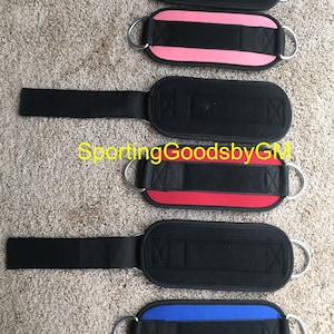 May include: Five ankle straps for weightlifting, each with a black strap and a different colored pad: black, pink, red, blue, and black. The straps have a metal ring on each end.