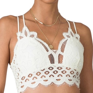 May include: White lace bralette with adjustable straps and a scalloped hem.