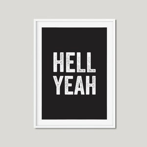 May include: A black and white framed print with the text "HELL YEAH" in a white distressed font.