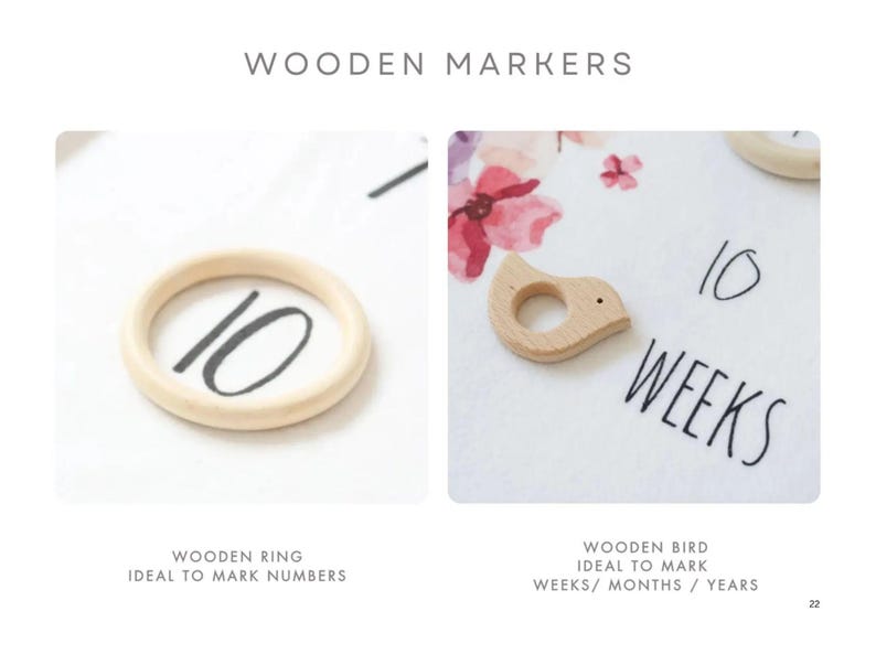 May include: Two wooden markers for a baby milestone blanket. One is a ring with the number 10 written on it. The other is a bird shape with a hole in the middle. The text "10 WEEKS" is written on the blanket.