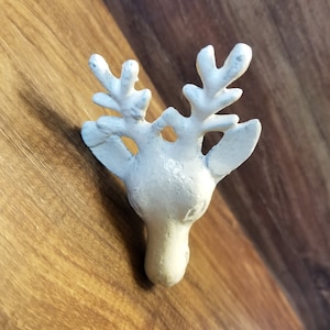 May include: White ceramic deer head wall hook with antlers.
