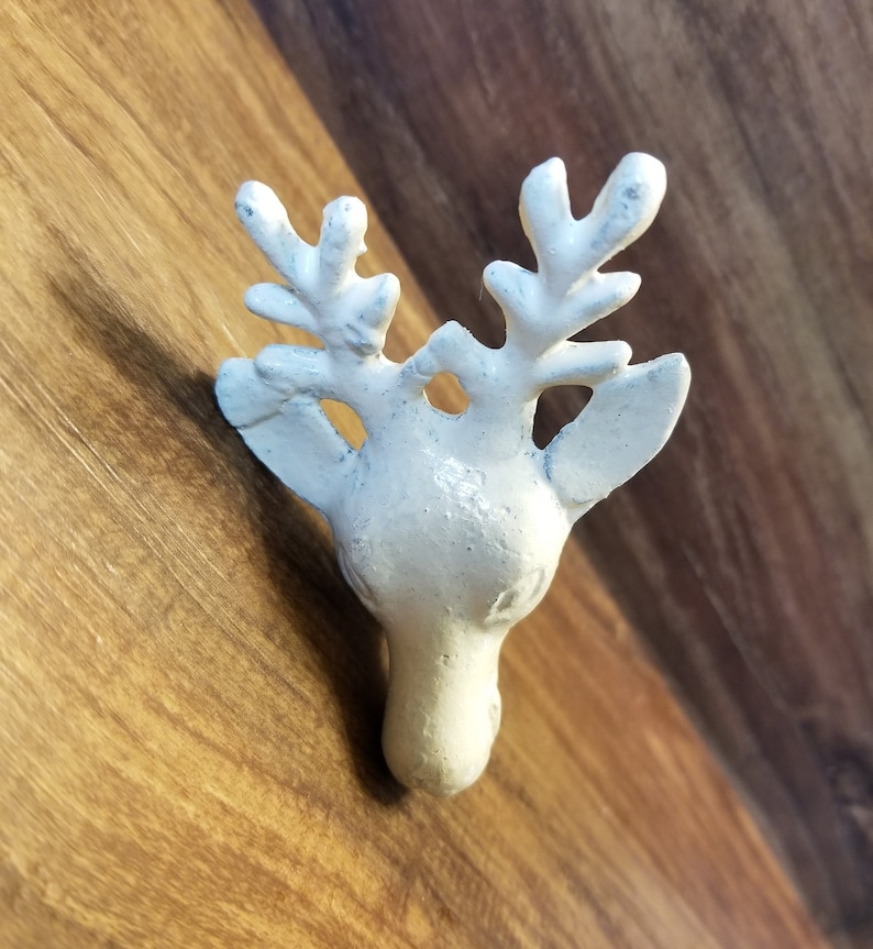 May include: White ceramic deer head wall hook with antlers.