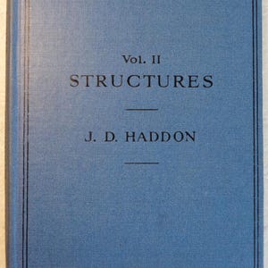 May include: A blue book with the title "An Introduction to Aeronautical Engineering, Vol. II Structures" by J.D. Haddon. The book is 7/6 net.