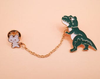 Joli personnage tenant un dinosaure en laisse - Pin's double émail !