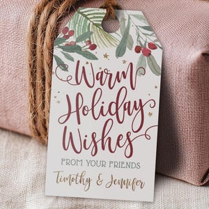May include: A gift tag with the words "Warm Holiday Wishes" in burgundy script, adorned with botanical illustrations and gold accents. The tag is attached to a wrapped present with twine.