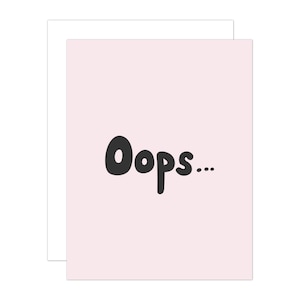 May include: A pink card with the word "Oops..." written in black, bubbly letters.