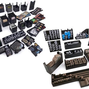 May include: A collection of black, 3D-printed game organizers and storage containers. The organizers are designed to hold game cards, tokens, and miniatures. Various sizes and shapes are shown, suitable for board games.