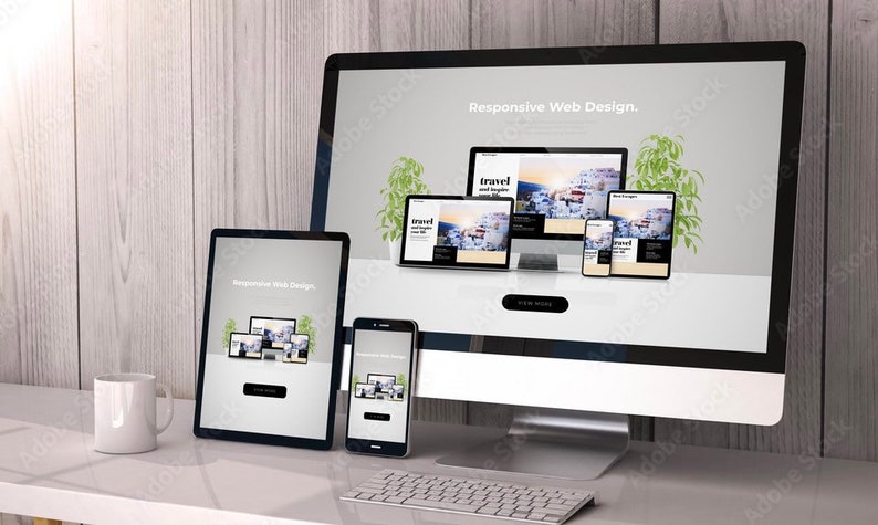 May include: A desktop computer, tablet, smartphone, and laptop all displaying the same website design. The website is for a travel company and features a picture of a white building with blue accents. The text on the website says "Responsive Web Design." and "Travel and Explore".