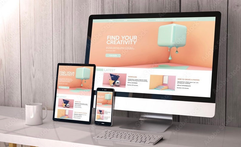 May include: A desktop computer, tablet and smartphone are displayed on a desk. The computer screen shows a website with the text "Find Your Creativity" and a 3D graphic of a light blue cube dripping with blue paint. The tablet and smartphone screens show similar designs with the same text.