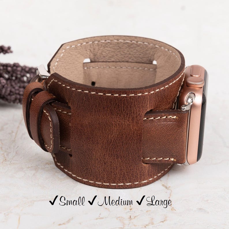 Personalized leather cuff watch band handcrafted from genuine leather, offering a stylish and durable design. Available in small, medium, and large sizes, with custom engraving options for names, initials, or logos. Compatible with Apple Watch Ultra, Series 10-1, SE (38mm, 40mm, 41mm, 42mm, 44mm, 45mm, 49mm), Samsung Galaxy Watch (41mm, 42mm, 43mm, 44mm, 45mm, 46mm), Fitbit Versa and Sense models, Google Pixel Watch (41mm, 45mm), and Fossil and Garmin watches with 18mm, 20mm, and 22mm bands