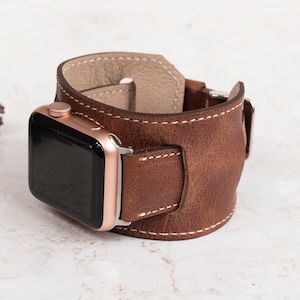 Custom engraved genuine leather cuff watch band handcrafted for a unique look. Made from premium leather and available in small, medium, and large sizes. Compatible with Apple Watch Ultra, Series 10, 9, 8, 7, 6, 5, 4, 3, 2, 1, SE (38mm, 40mm, 41mm, 42mm, 44mm, 45mm, 49mm), Samsung Galaxy, Fitbit, Google Pixel, Fossil, and Garmin watches