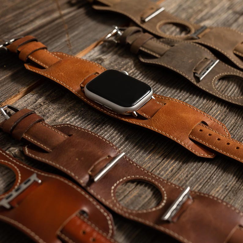 Handcrafted leather cuff watch band designed for a vintage look, made from premium genuine leather for comfort. Available in small, medium, and large sizes, with custom engraving options for names, initials, or logos. Compatible with Apple Watch Ultra, Series 10-1, SE (38mm, 40mm, 41mm, 42mm, 44mm, 45mm, 49mm), Samsung Galaxy Watch (41mm, 42mm, 43mm, 44mm, 45mm, 46mm), Fitbit Versa and Sense models, Google Pixel Watch (41mm, 45mm), and Fossil and Garmin watches with 18mm, 20mm, and 22mm bands