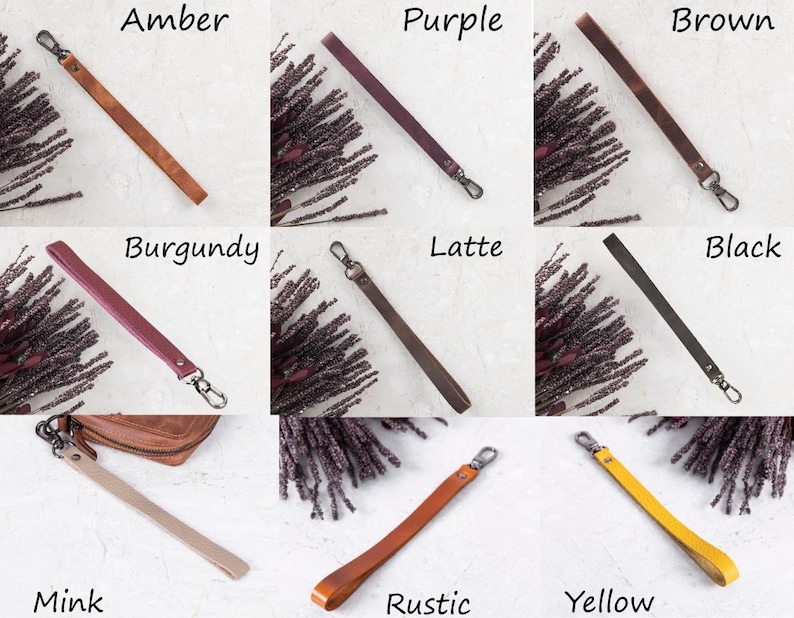 May include: A collection of leather wrist straps in various colors, including amber, purple, brown, burgundy, latte, black, mink, rustic, and yellow. Each strap has a metal clasp for attachment. The straps are displayed on a light-colored surface.