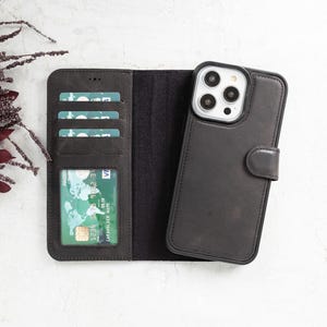 Black genuine leather iPhone wallet case with a detachable magnetic phone cover, multiple card slots, and a secure magnetic flap closure. Sleek and functional design for everyday use. Compatible with iPhone 16, 15, 14, 13, 12, 11, XR, XS, X, 8, 7, SE, Pro, Max, Mini.