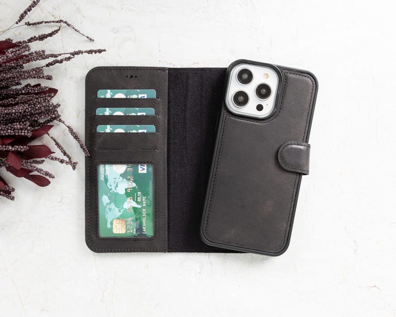 Black genuine leather iPhone wallet case with a detachable magnetic phone cover, multiple card slots, and a secure magnetic flap closure. Sleek and functional design for everyday use. Compatible with iPhone 16, 15, 14, 13, 12, 11, XR, XS, X, 8, 7, SE, Pro, Max, Mini.