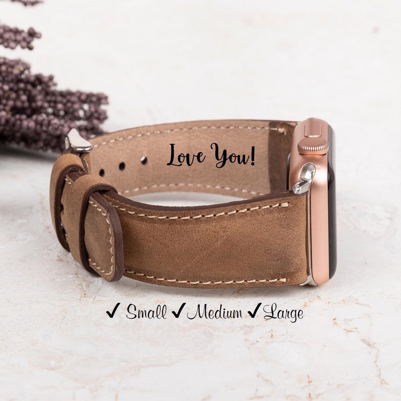 Personalized genuine leather Apple Watch band with "Love You!" engraving. Hand-stitched edges, available in Small, Medium, and Large sizes. Compatible with Apple Watch 38mm, 40mm, 41mm, 42mm, 44mm, 45mm, 49mm, Samsung Galaxy, Fitbit, Garmin, Fossil, and Google Pixel watches.