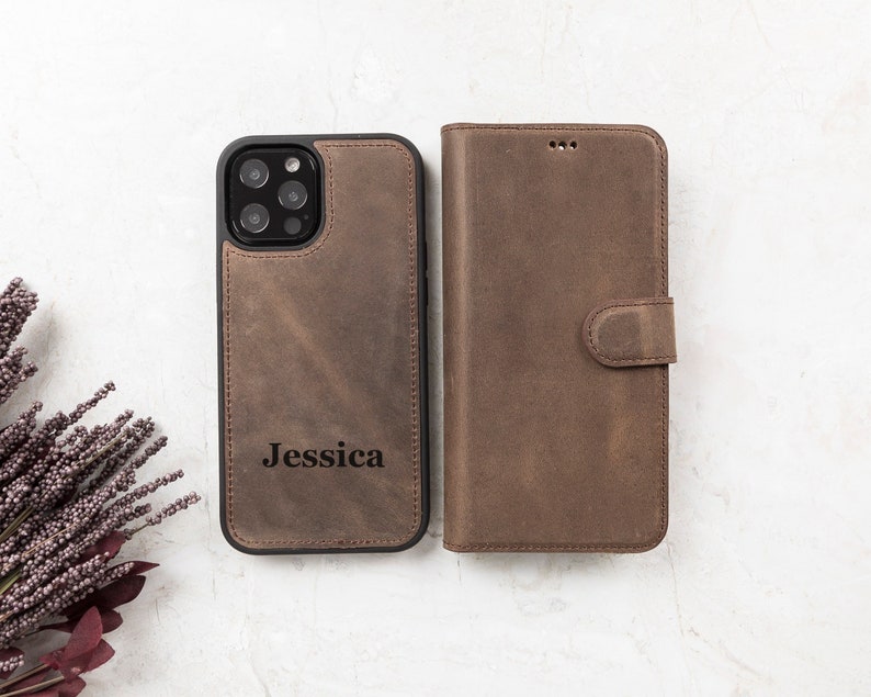 Brown genuine leather iPhone wallet case with engraved personalization on the detachable magnetic phone cover. Features a secure magnetic flap closure and a stylish, durable design. Compatible with iPhone 16, 15, 14, 13, 12, 11, XR, XS, X, 8, 7, SE, Pro, Max, Mini. Perfect for everyday use or as a personalized gift
