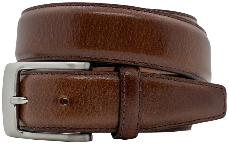 May include: A brown belt with a textured surface and visible stitching along the edges. The belt features a rectangular silver-toned metal buckle with a single prong and a matching leather keeper loop to secure the strap in place.