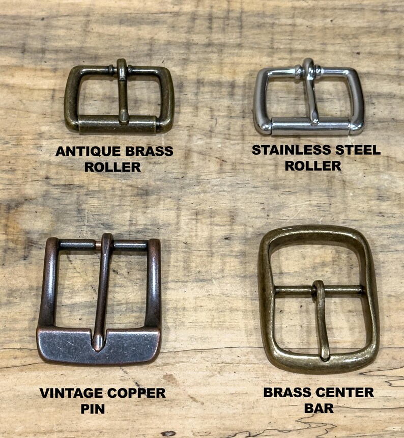 May include: Four metal belt buckles in antique brass, stainless steel, vintage copper, and brass. Each buckle has a different design, including roller and pin styles. The text labels each buckle's material and style.