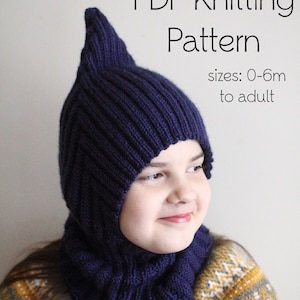 May include: A dark blue knitted hat and neck warmer with a pointed top. The hat is worn by a child with a patterned sweater. The text "PDF Knitting Pattern" and "sizes: 0-6m to adult" is visible in the image.