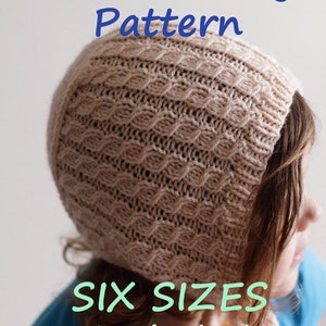 May include: A PDF knitting pattern for a beige knitted hat with a cable stitch design. The pattern includes six sizes. The text "PDF Knitting Pattern" and "SIX SIZES included" is visible in the image.