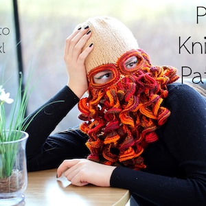 May include: A PDF knitting pattern for a crocheted hat with a curly beard. The hat is beige with a red and orange beard. The pattern is available in sizes 8-12 years to adult XL.