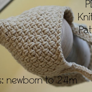 May include: A beige crocheted baby hat with a pointed top and ties. The hat is displayed on a wooden surface. The text "PDF Knitting Pattern" and "sizes: newborn to 24m" is visible in the image.
