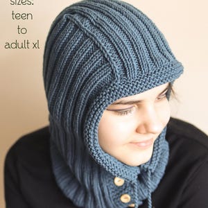 May include: A blue knitted hooded cowl with a drawstring and buttons. The cowl is made with a ribbed stitch pattern.  PDF Knitting Pattern. Sizes: Teen to Adult XL.